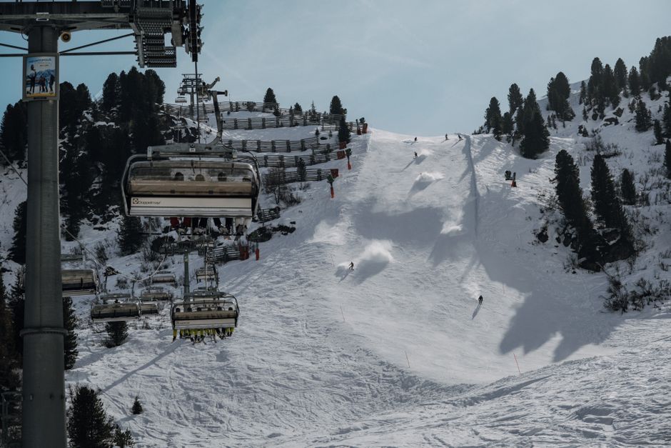 A chairlift rising over snowy ski slopes