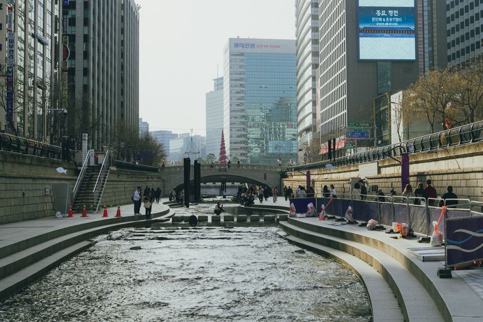 Cheonggyecheon Stream Seoul with waterfalls and city buildings above