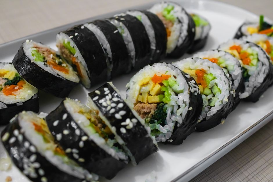 Gwangjang market food stall with Korean mayak gimbap and side dishes