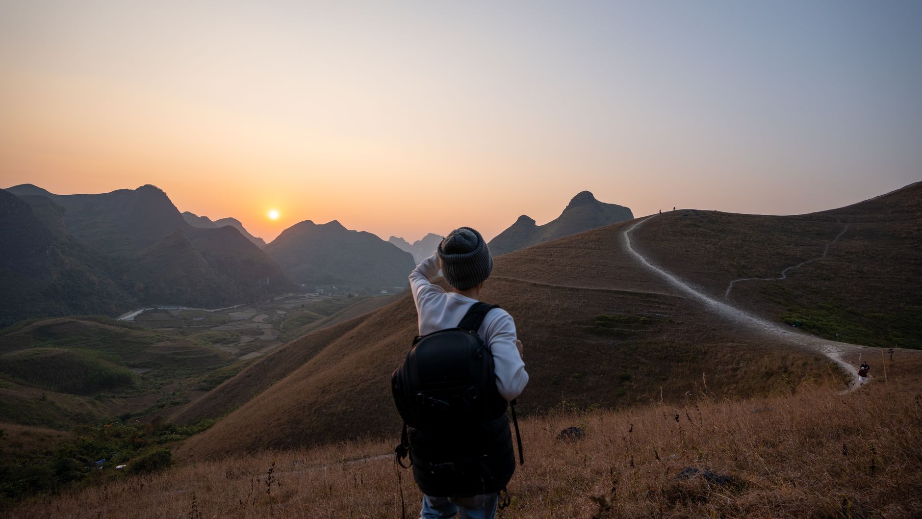 Hiker on mountain summit overlooking Seoul skyline panorama